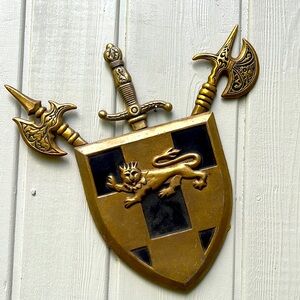 Vintage cast metal (brass?) shield wall hanging. Circa 1966.